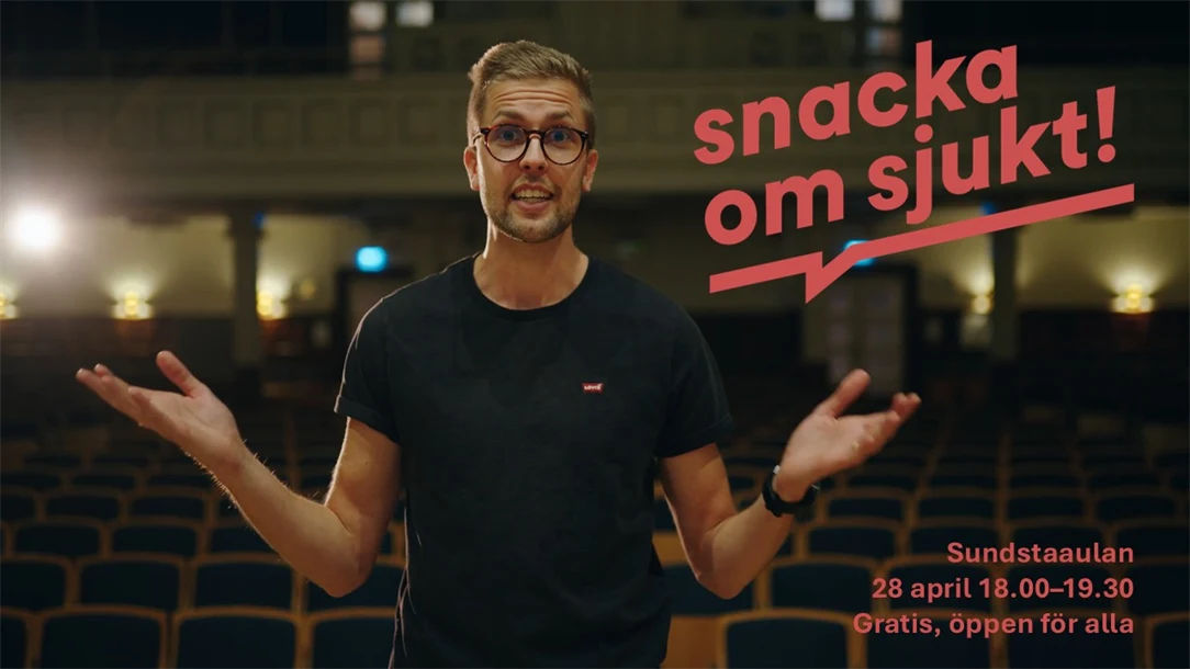 En person gestikulerar med händerna på en scen.