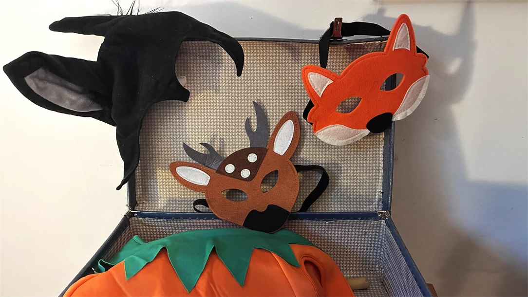 Låda med teatermasker och tyg